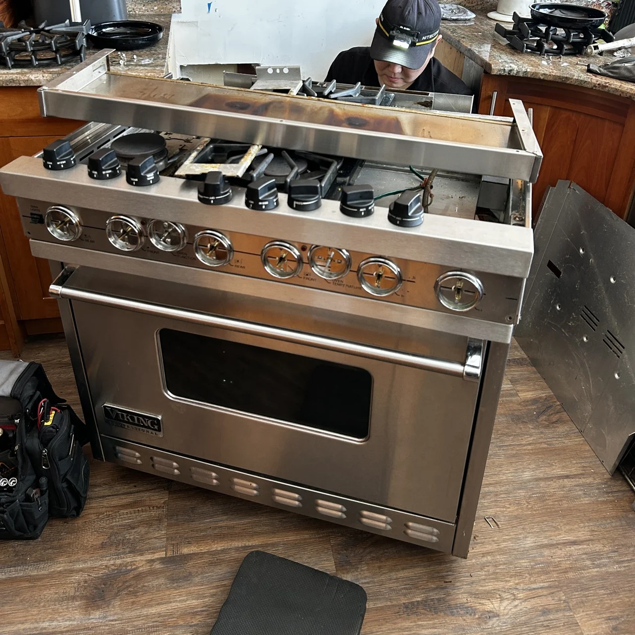 Technician beside a disassembled Viking range from the owner’s work archive